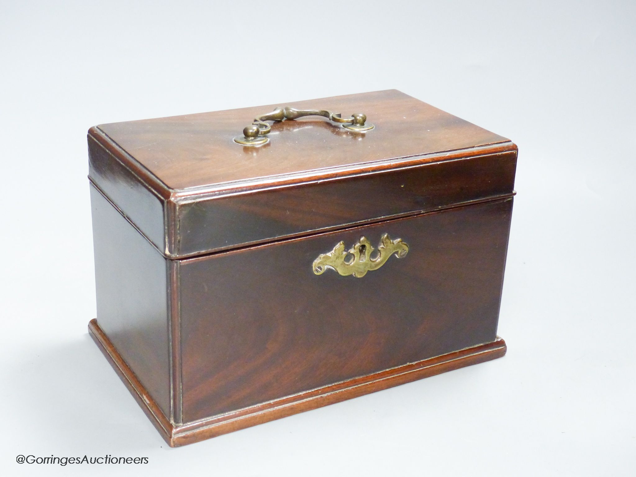 A George III mahogany tea caddy, with a concealed drawer to one end, width 22cm height 14cm